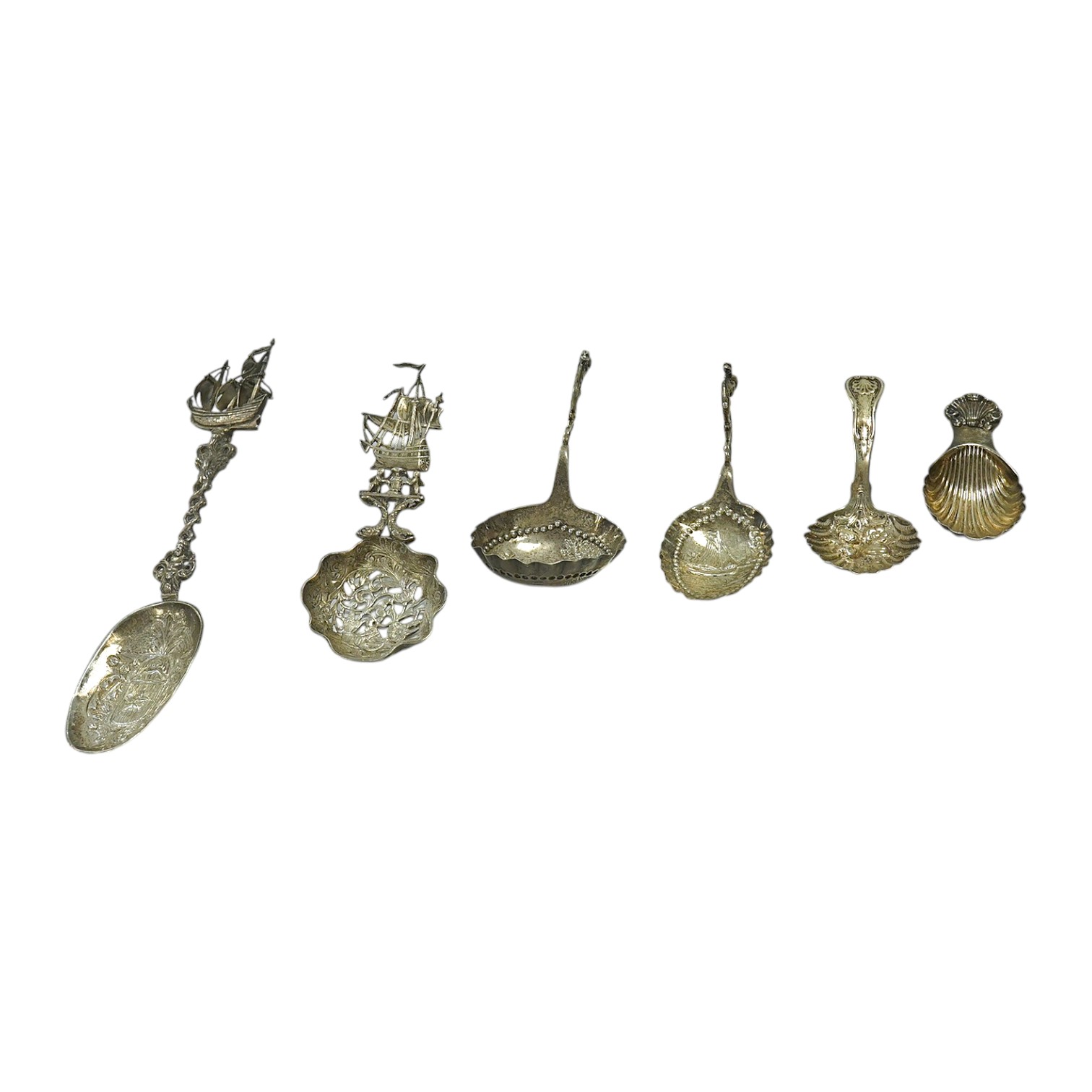 A Victorian Scottish embossed silver King's pattern caddy spoon, Millidge & Son, Edinburgh, 1854, 10.5cm, together with a later silver caddy spoon, a silver Hanau spoon and three other continental white metal spoons incl